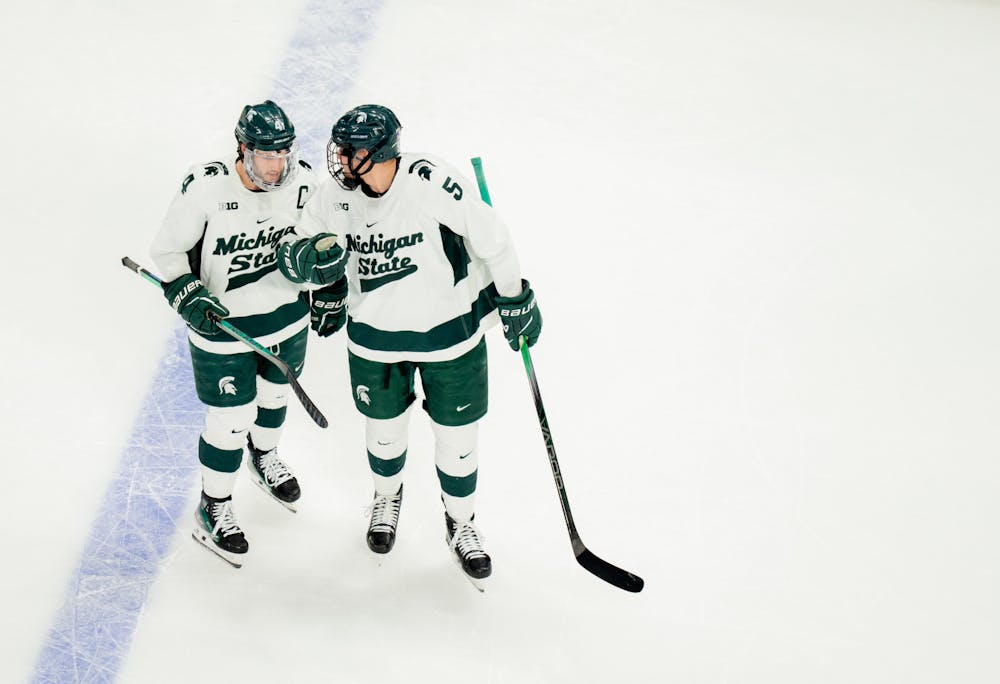 <p>MSU defenseman and captain Nash Nienhuis (left) and forward Artyom Levshunov speak briefly in between plays at Little Caesars Arena on Saturday, Feb. 10, 2024, for the "Duel in the D." MSU came away with a 3-2 victory after resisting a late-game U of M comeback.</p>