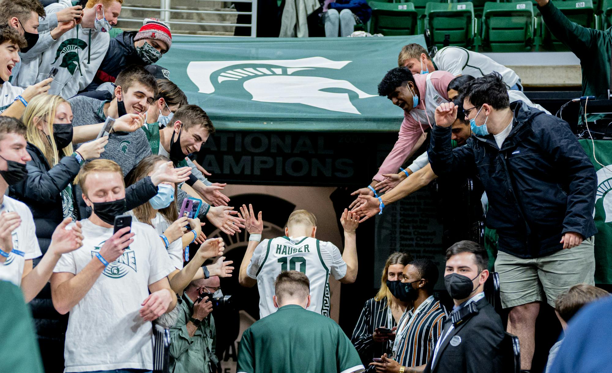 <p>Redshirt senior forward Joey Hauser high-fives fans after the Spartans&#x27; 71-69 win against Minnesota on Jan. 12, 2022. Hauser hit the game-winning shot.</p>