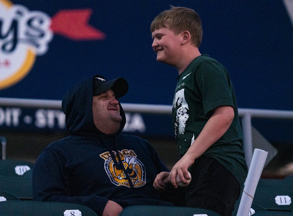 <p>MSU fan celebrating with his father after snagging a foul ball late in the sixth inning at Jackson Field on April 7, 2023.</p>