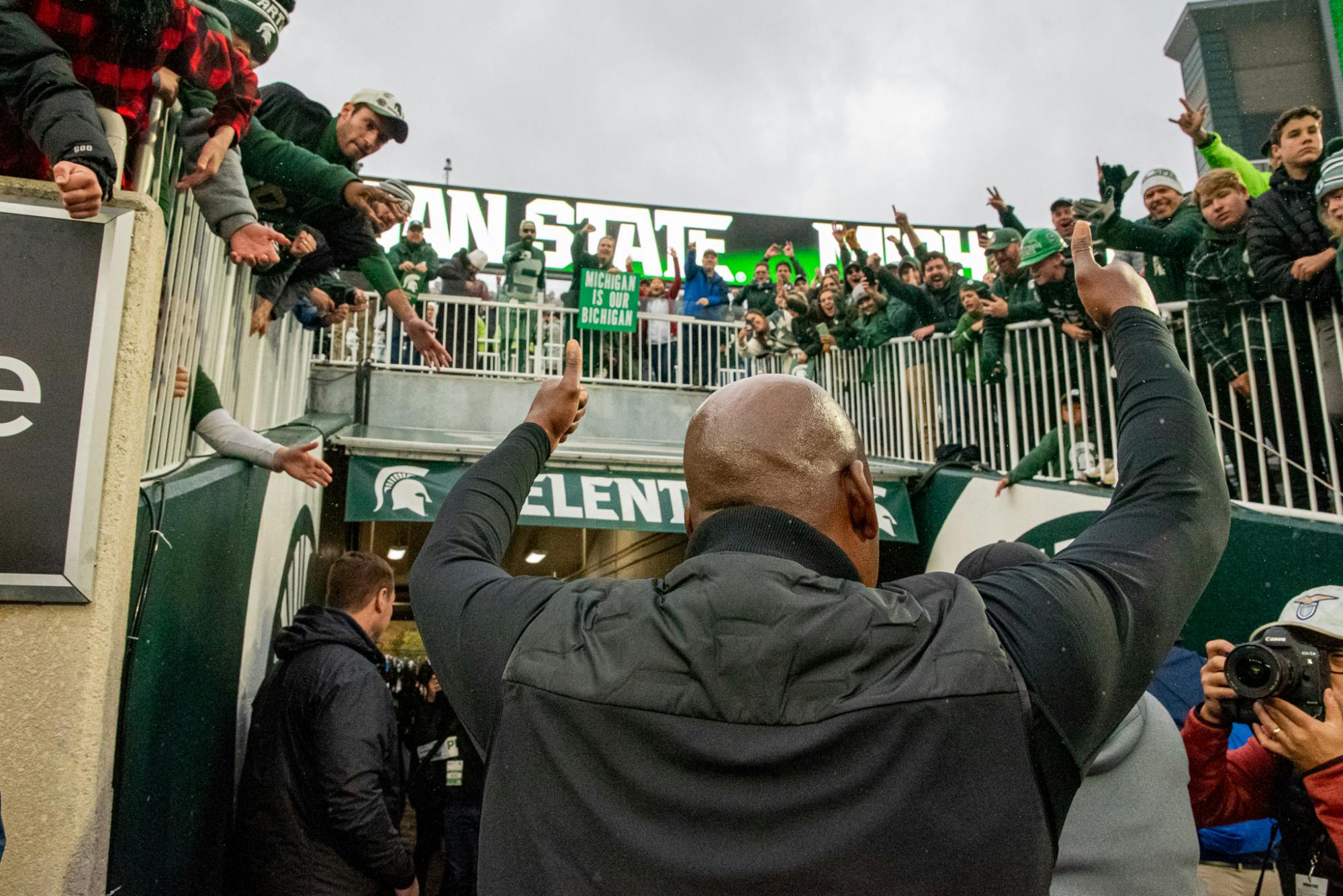 <p>Head Coach Mel Tucker gives thumbs up to Spartan fans after the Spartans raced back from a 16-point deficit to beat the Wolverines on Oct. 30, 2021.</p>