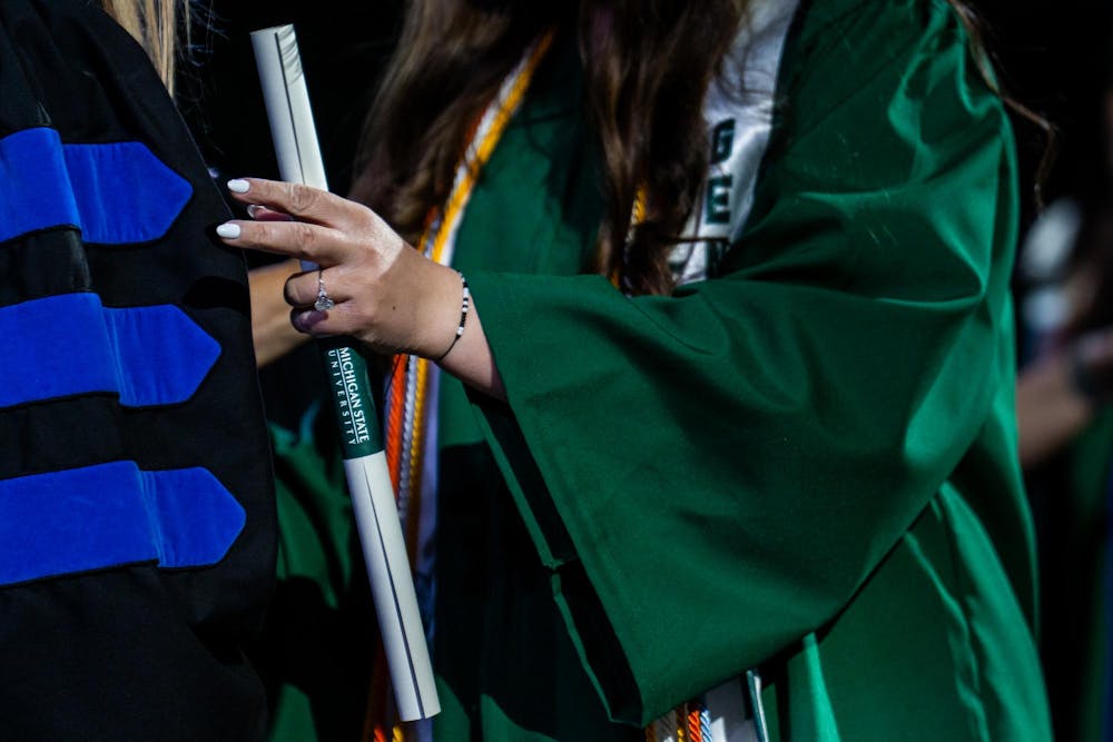 A graduate receives their diploma during the Michigan State University College of Communication Arts and Sciences graduation ceremony at the Breslin Student Events Center on Michigan State University’s campus in East Lansing, Mich., on Friday, May 1, 2026.