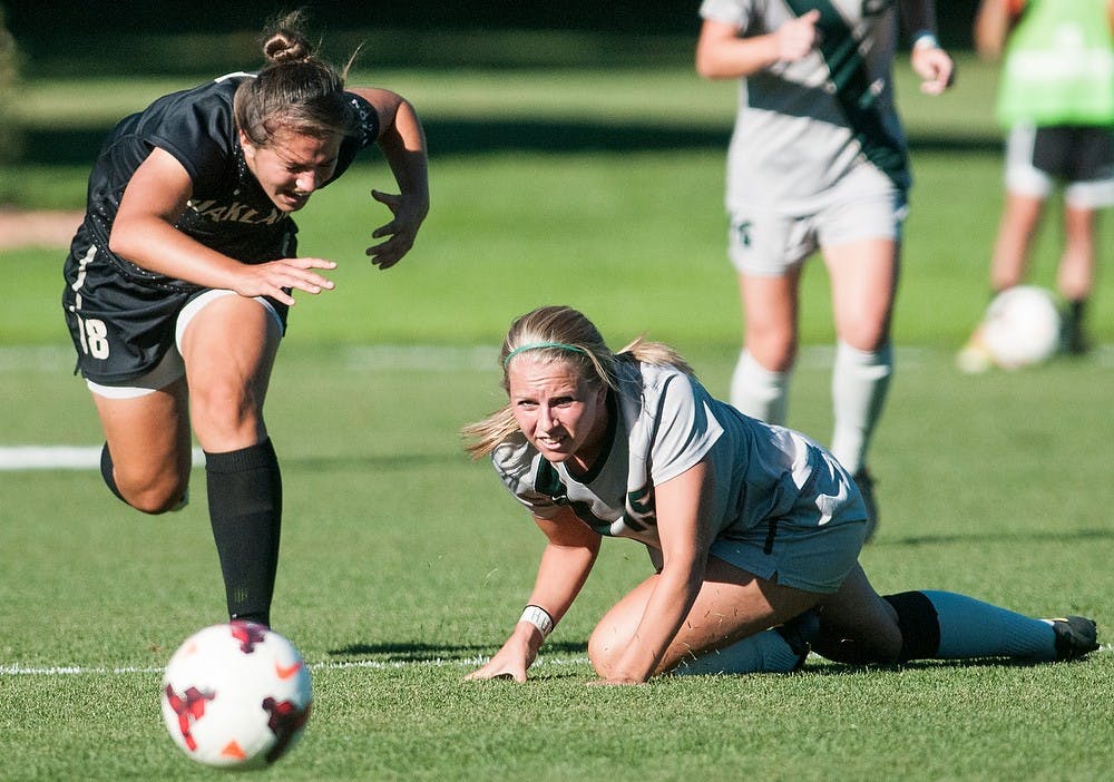 	<p>Senior midfielder/ defender Kelsey Mullen falls to the ground after making contact with Oakland midfielder Abigail Haelewyn during the match Sept. 5, 2013  at DeMartin Stadium. The Spartans tied the Grizzlies, 1-1, after playing two scoreless overtime periods. Khoa Nguyen/ The State News</p>