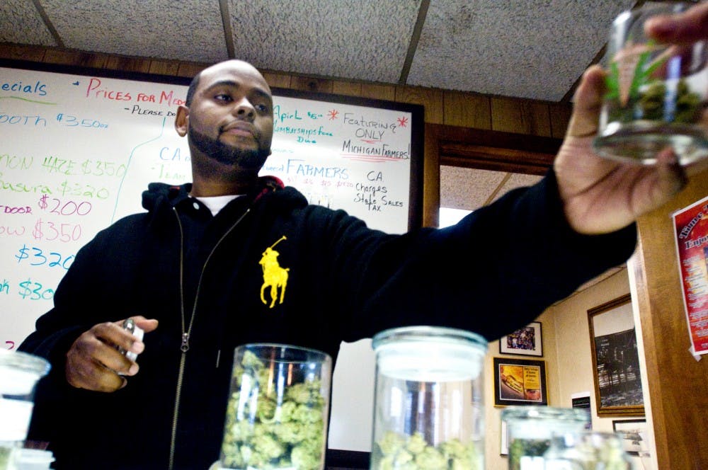 	<p>Compassionate Apothecary employee Brandon Smurf hands over a jar of medicinal marijuana to a customer Wednesday afternoon at Compassionate Apothecary of Lansing. The business’ owner, Ken Van Every, said he’s been extremely busy for the past week with people stocking up for Wednesday’s unofficial marijuana holiday. “It’s just been nonstop all day yesterday and all day today,” Van Every said.</p>