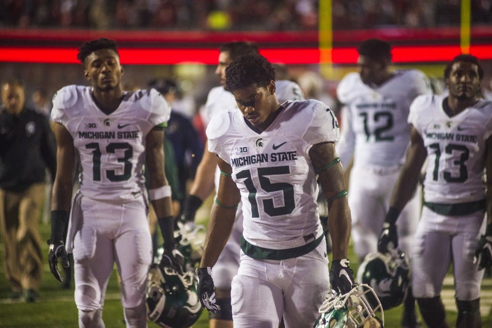 The Spartans walk off the field after losing the game against Indiana on Oct. 1, 2016 at Memorial Stadium in Bloomington, Ind. The Spartans were defeated by the Hoosiers in overtime, 24-21.