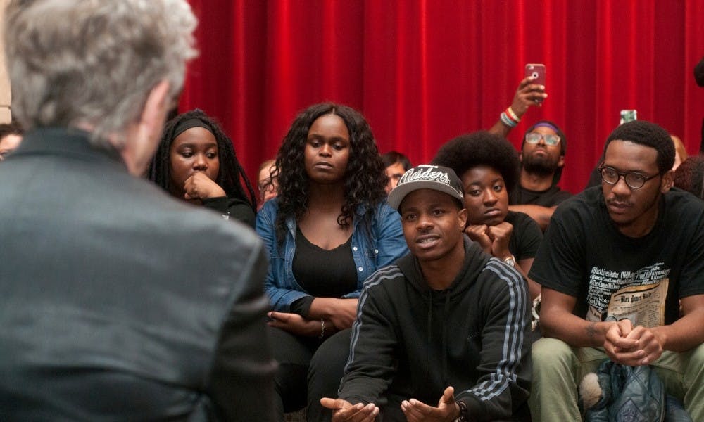 Graduate student AJ Rice talks with President Lou Anna K. Simon about the concerns of the African American community on campus during a protest on Nov. 18, 2015, at the Kellogg Center. The group of students gathered for National Blackout Day and then protested on Harrison Avenue and in the Kellogg Center for the university to address their concerns about their safety and about racism on campus.