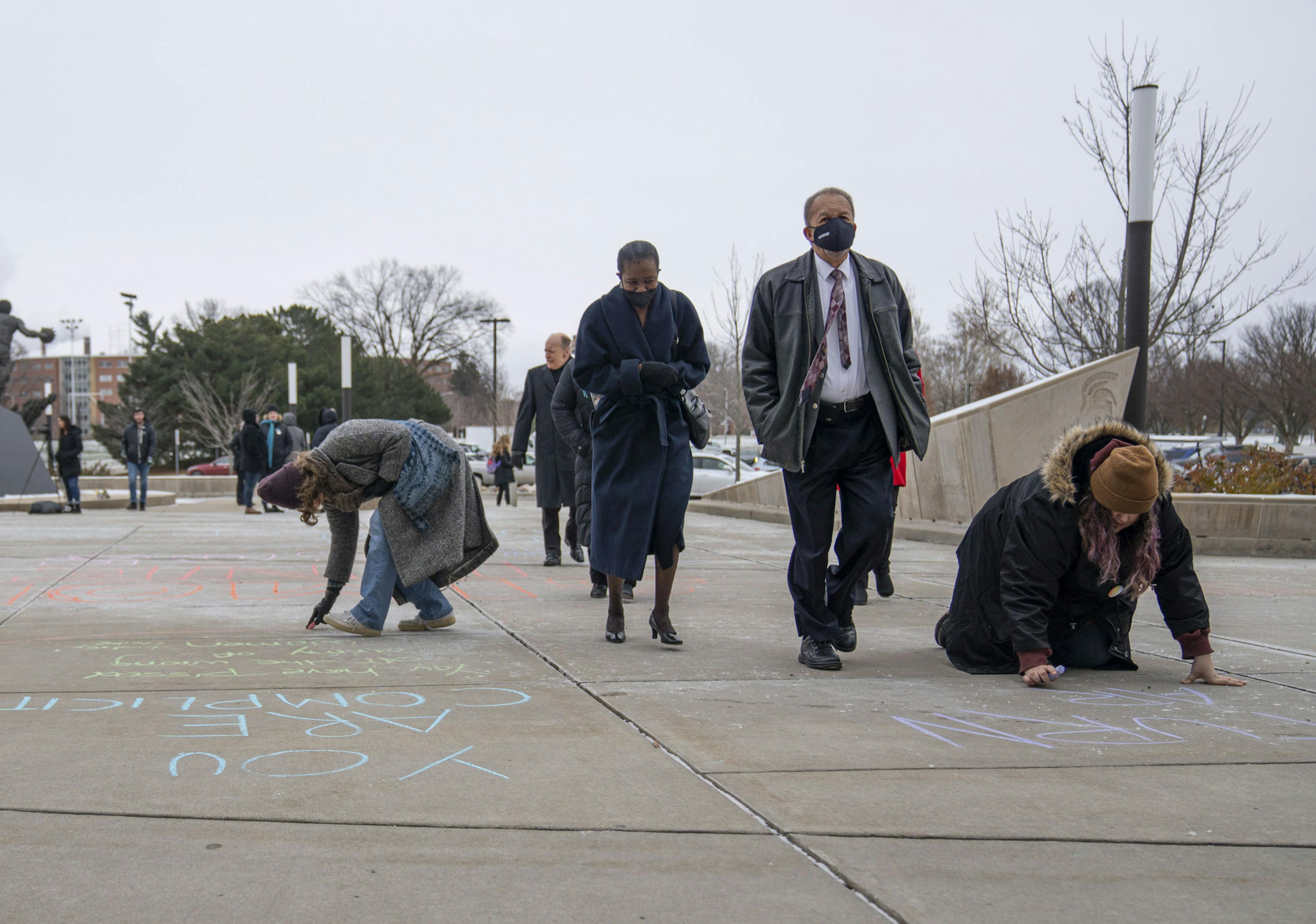 <p>Attendees walk past protestors into the Breslin Center for the unveiling of former president Lou Anna K. Simon’s portrait on Monday, Dec. 19, 2022. Simon resigned in 2018 due to her involvement in the sexual assault scandal from a former Michigan State doctor. </p>