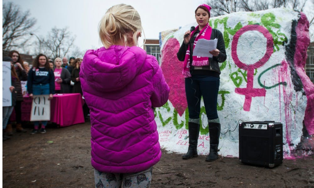 <p>A girl listens as Ann Arbor resident Lauren Bacons speaks to the crowd during the rally to support Planned Parenthood on Feb. 10, 2017 at the Rock on Farm Lane. The rally was to support Planned Parenthood and women&#x27;s rights. Sen. Rebekah Warren and Harmeet Dhaliwal, who is a doctor at Sparrow Hospital and professor at MSU, spoke at the rally.</p>