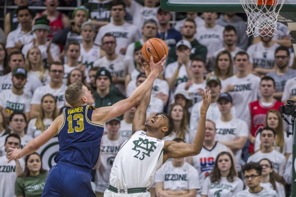 Freshman forward Xavier Tillman (23) covers Michigan forward Moritz Wagner (13) during the men's basketball game against Michigan on Jan. 13, 2018 at Breslin Center. The Spartans were defeated by the Wolverines, 82-72. (Nic Antaya | The State News)