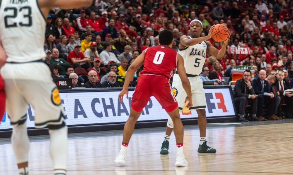 Junior guard Cassius Winston (5) is defended by Wisconsin's D'Mitrik Trice. The Spartans beat the Badgers, 67-55, at the United Center on March 16, 2019.