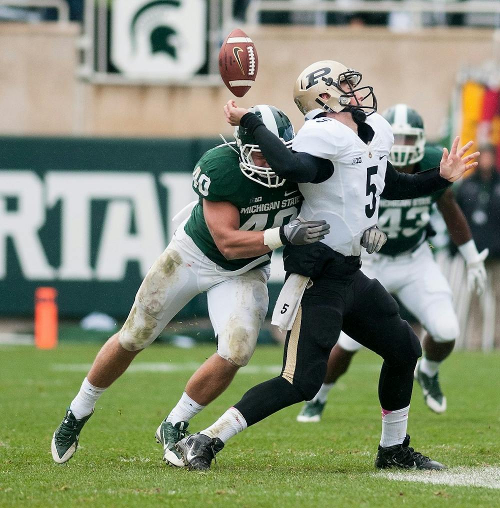 	<p>Senior linebacker Max Bullough sacks Purdue quarterback Danny Etling during the game Oct. 19, 2013, at Spartan Stadium. Etling fumbled the ball, which then was picked up by senior linebacker Denicos Allen for the first touchdown of the game. Danyelle Morrow/The State News</p>
