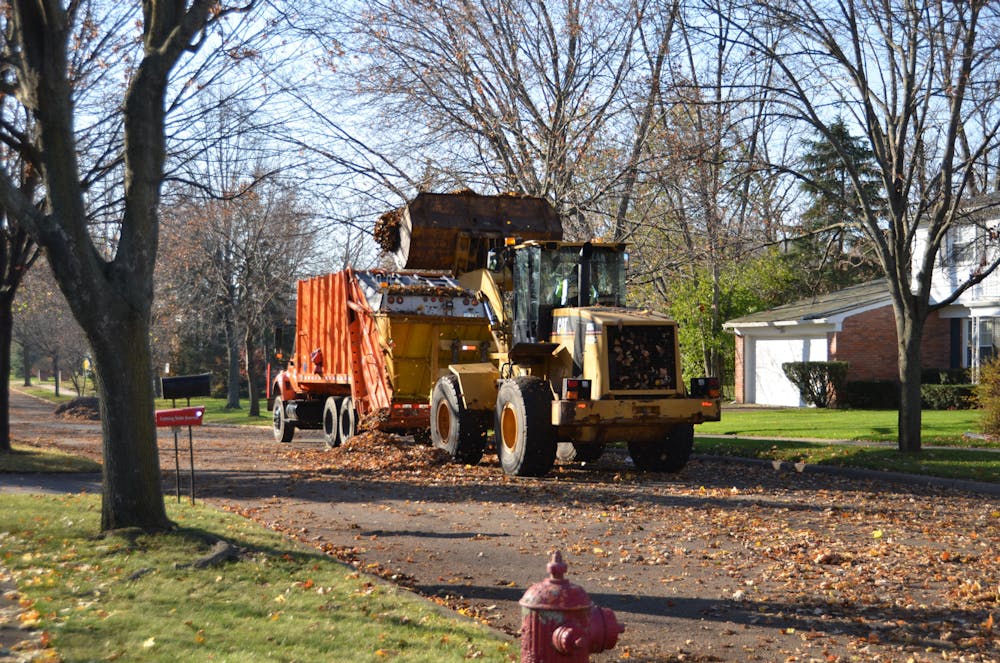 <p>A yard waster truck drives down a neighborhood street. Photo courtesy of the City of East Lansing. </p>