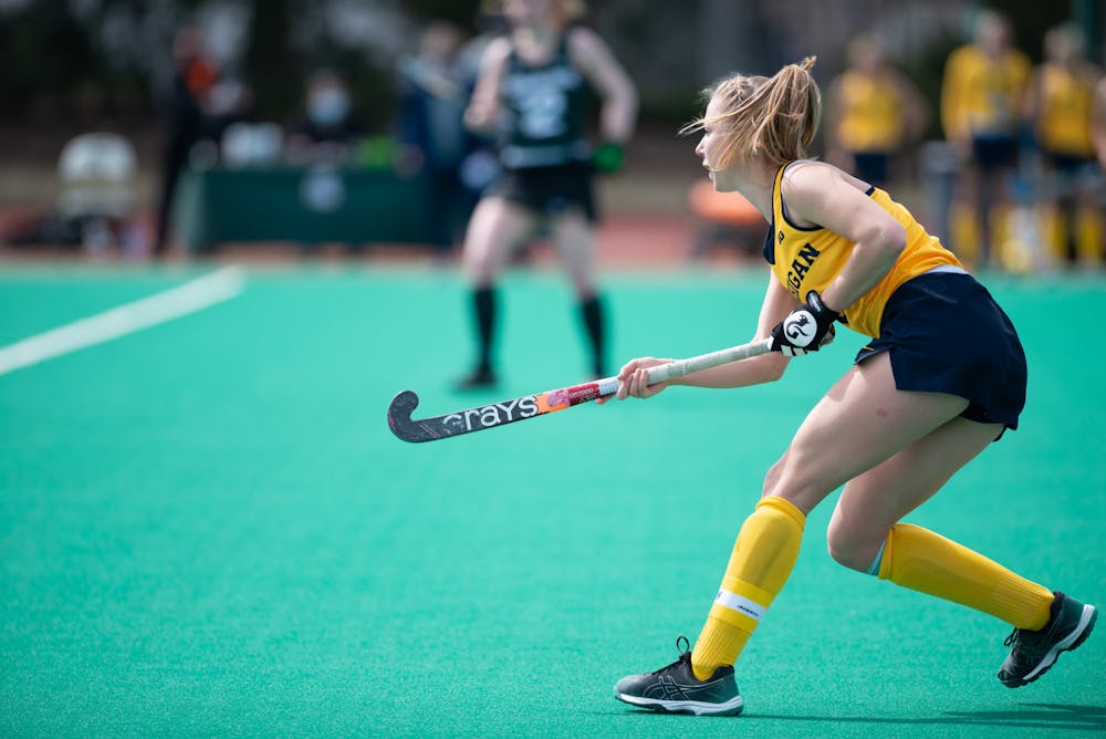 Michigan graduate student Clare Brush passes the ball downfield an away game against MSU on April 2, 2021.