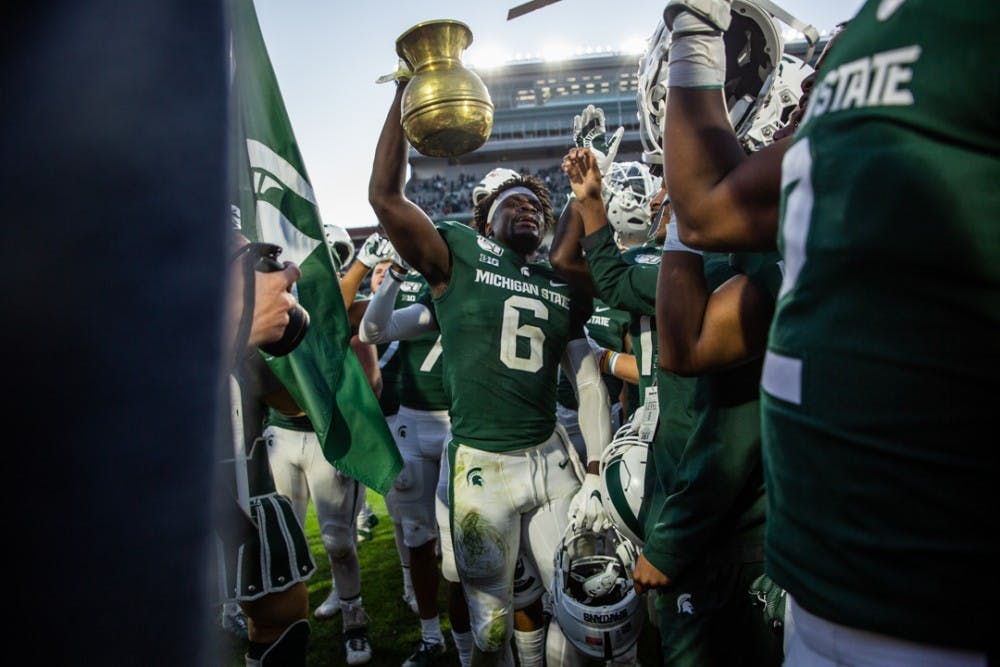 Spartans hold up their spittoon trophy during the homecoming game against Indiana on Sept. 28, 2019 at Spartan Stadium. The Spartans beat the Hoosiers, 40-31.