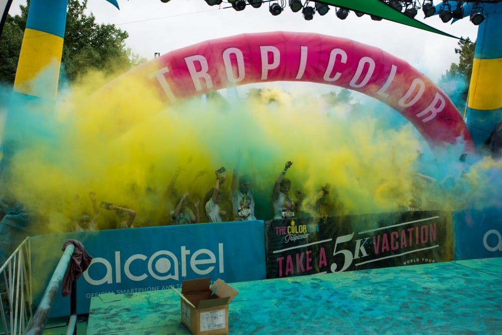 Colorful powder floats in the air after a "color throw" occurs during The Color Run Tropicolor World Tour on July 9, 2016 in Lansing, Mich. After Color Runners finish their race, they celebrate at the Finish Festival which features dancing, music and color throws every 15 minutes.
