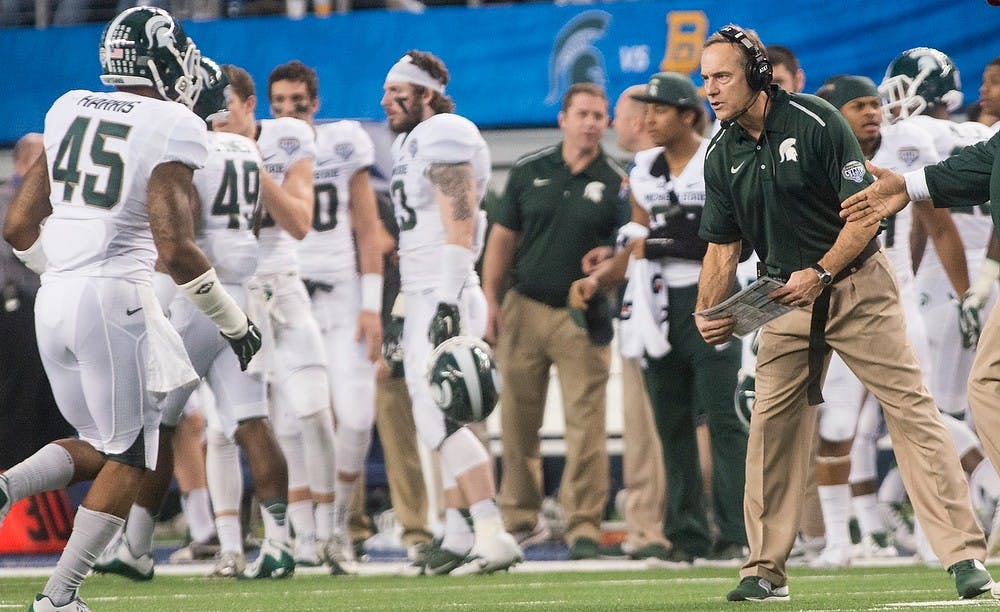 <p>Head coach Mark Dantonio greets his team as they come in for a time out Jan. 1, 2015, during The Cotton Bowl Classic football game against Baylor at AT&amp;T Stadium in Arlington, Texas. The Spartans defeated the Bears and claimed the Cotton Bowl Victory, 42-41. Erin Hampton/The State News</p>