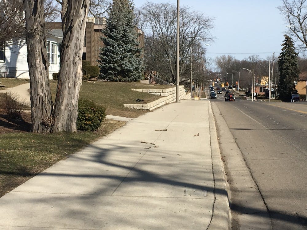 This stretch of Abbot Road, between Fern Street and Oakhill Avenue, was the beneficiary of a $134,330 project to widen the sidewalk and rebuild a retaining wall. Photo courtesy of the City of East Lansing