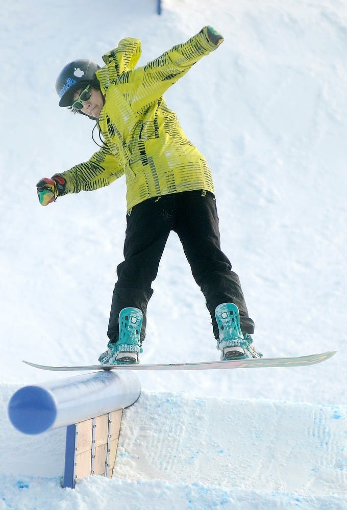 	<p>Northwood University student Mike Tonz does a front board slide down the mountain Jan. 5, 2013, at Hawk Island Snow Park 1601 E. Cavanaugh Rd., in Lansing. Tonz said he was there with Middle Earth Snowboard Series, which hosts snowboard events throughout Michigan. Natalie Kolb/The State News</p>