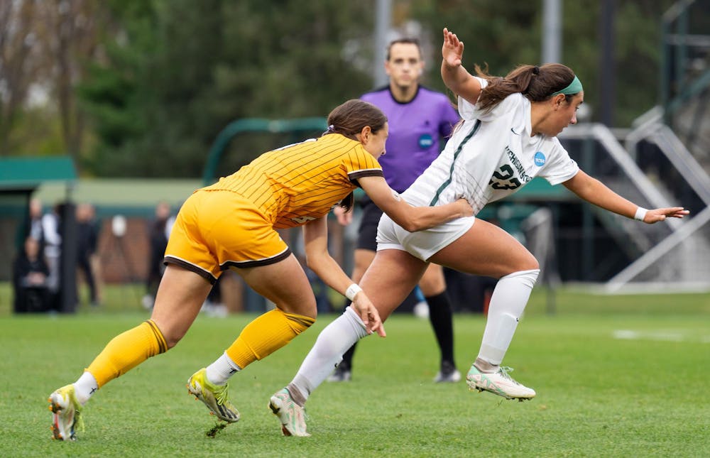 <p>Western Michigan University senior forward Abby Werthman (8) grabs Michigan State University sophomore forward/midfielder Bella Najera (23) while running for the ball during the NCAA soccer tournament between MSU and WMU on Nov. 16, 2024. The Spartans defeated the Broncos, 3-1.</p>