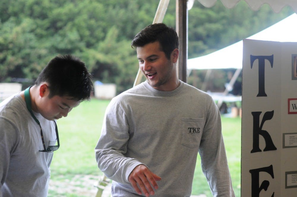 <p>Finance junior Nick Lochinski, right, shares a laugh with Tau Kappa Epsilon brother and marketing sophomore Mark Debney during Greek Fall Welcome on Sept. 3, 2015, at the Rock on Farm Lane. Tau Kappa Epsilon was reinstated this fall at Michigan State. Kennedy Thatch/The State News</p>