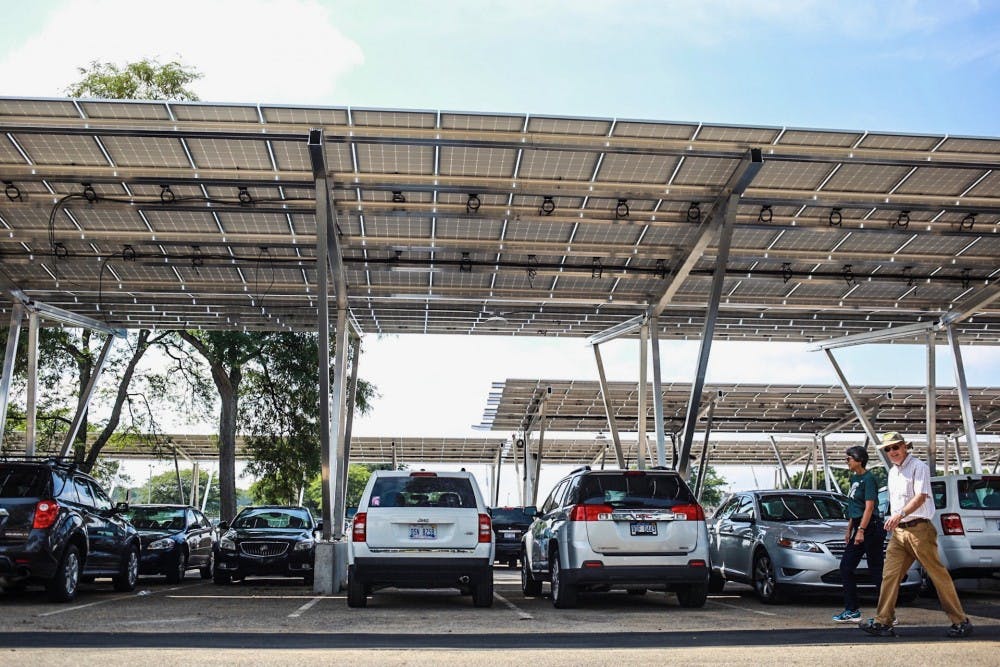  New solar panels are installed on Michigan State University's campus over the parking lot at Hagadorn and Service Roads pictured on Tuesday, Aug. 29, 2017. 