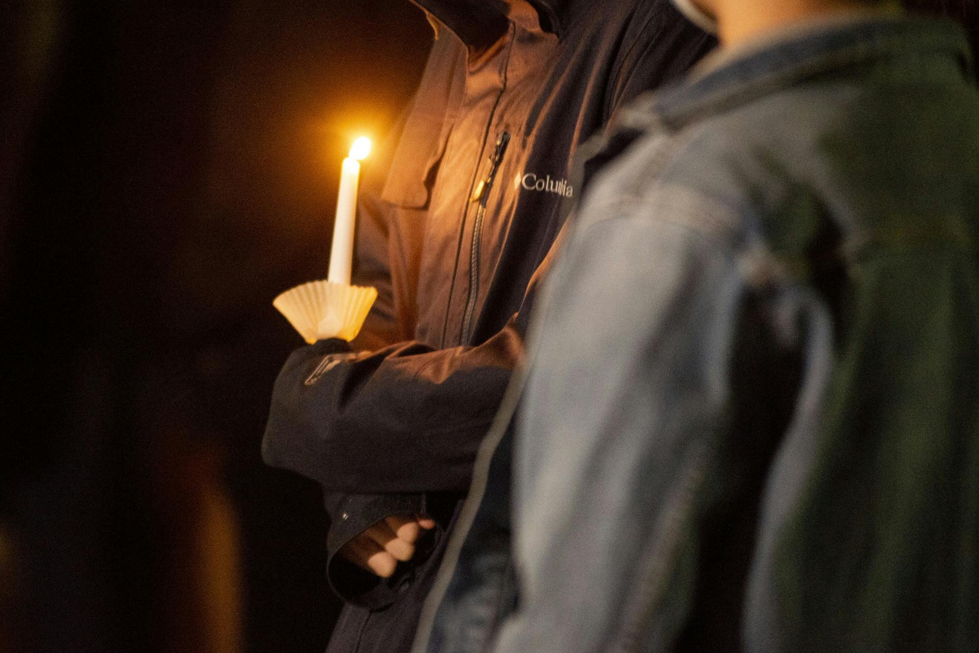 <p>A lit candle was held at the vigil in remembrance of Phat Nguyen on Nov. 29, 2021, at the Minskoff Pavillion.</p>