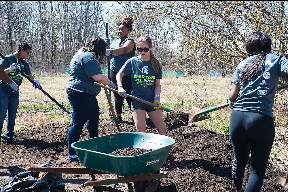 <p>Volunteers help out for Spartans WILL. POWER Global Day of Service April 18, 2015, at the Greater Lansing Food Bank community garden in East Lansing. The service day brings together spartan alumni, friends, students, faculty and staff from around the world to help their local communities. Hannah Levy/The State News</p>