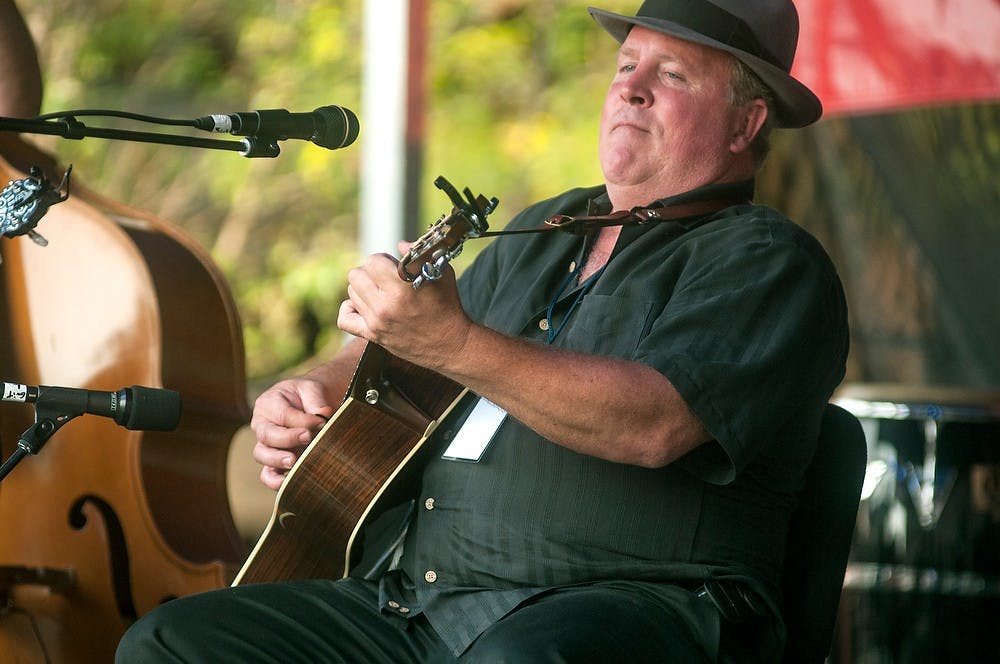 <p>Guitarist Daniel Rothwell plays with Maupin, Rothwell and Overall Creek during the Great Lakes Folk Festival on Aug. 8, 2014. The festival is produced by the MSU Museum's Michigan Traditional Arts Program. Jessalyn Tamez/The State News</p>