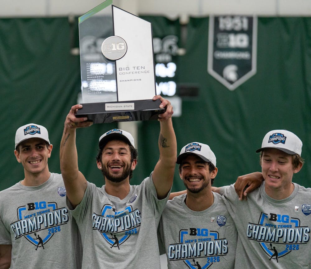 <p>Michigan State senior Ozan Baris celebrates with the Big Ten Men's Tennis Title Trophy alongside teammates at the MSU Tennis Center in East Lansing, Mich. on Sunday, April 19, 2026.</p>