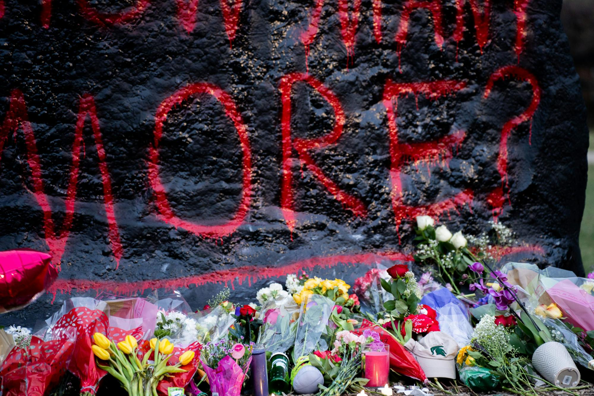 Hundreds of flowers surround the Rock on Farm Lane to commemorate the injured and lost Spartans on Feb. 14, 2023 following a mass shooting that took place on campus on Feb. 13, 2023. 