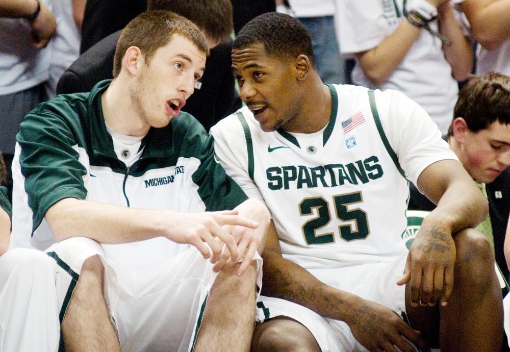 Sophomore centers Garrick Sherman and Derrick Nix talk on the bench during the game on Jan. 27 against Michigan at Breslin Center. Sherman and Nix have become good friends off the court as well as being teammates. Lauren Wood/The State News