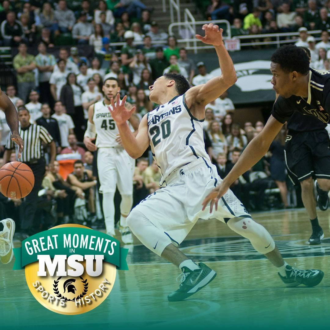 Then-senior guard Travis Trice gets hit by another player Mar. 4, 2015, during the game against Purdue at Breslin Center. The Spartans defeated the Boilermakers, 72-66. Photo by Emily Nagle. Design by Daena Faustino.