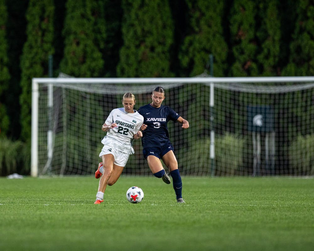<p>Michigan State Sr. M, Ella Janz (22) attacks the ball while trying to keep it away from an opponent in DeMartin Stadium in East Lansing, Mich., on Aug. 12, 2026.</p>