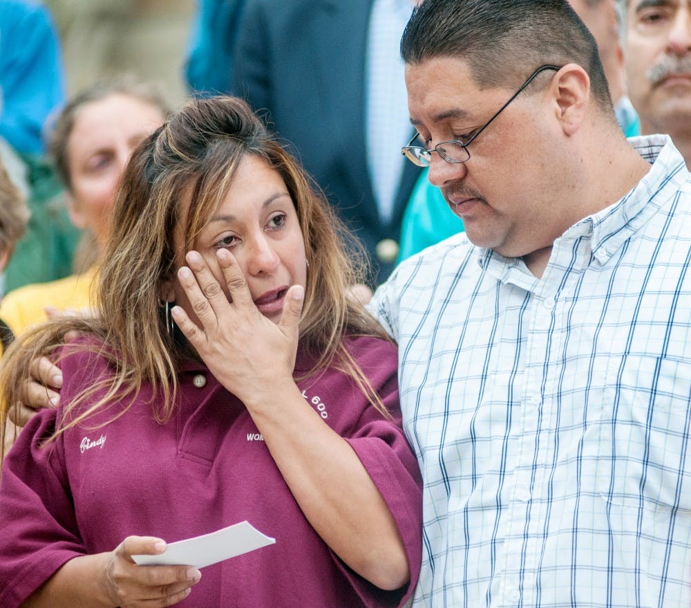 Cindy Garcia of Detroit is consoled by her husband Jorge Garcia on May, 31, 2012 in front of the Lansing State Capitol building as The Alliance for Immigrant Rights and Reform and and the Fair Immigration Reform Movement rallied to demand the Administration to keep immigrant families from deportation. Jorge Garcia, an illegal immigrant by law, might face possible deportation by the United State government in five weeks. Adam Toolin/The State News