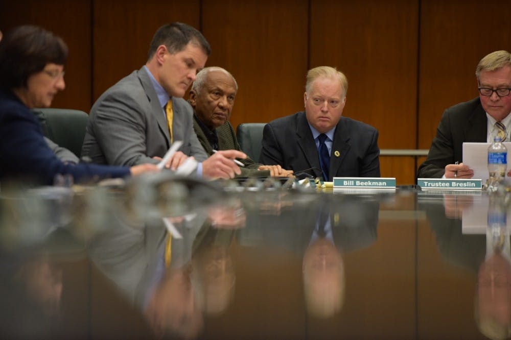 <p>William "Bill" Beekman sits with MSU trustees at a Board of Trustees meeting on Jan. 26 at the Hannah Administration Building. Beekman was appointed as acting president following the resignation of Lou Anna K. Simon.</p>
