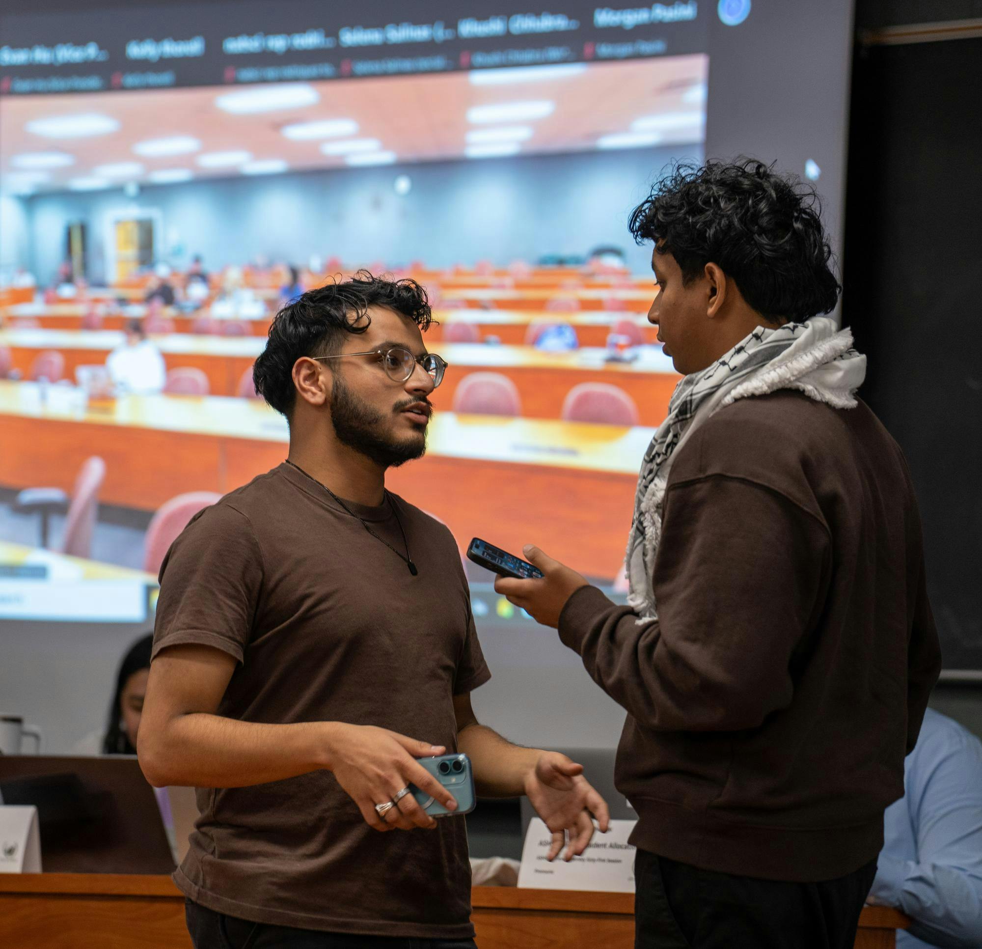 Ahmed Amir, Vice President for Academic Affairs for AMSU speaks to Amaan Abdul Mohi, Muslim Student Association Representative during the recess at the ASMSU General Assembly meeting in the International Center on Oct. 10, 2024.