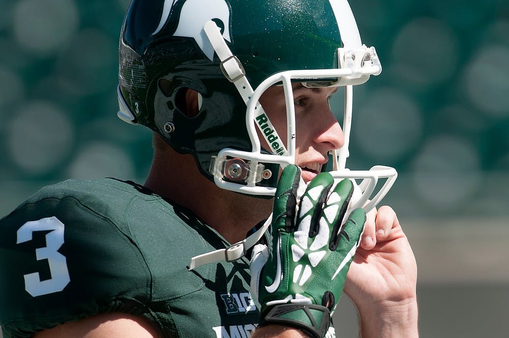 <p>Junior punter Mike Sadler adjusts his helmet on Sept. 14, 2013, at Spartan Stadium. The Spartans defeated Youngstown State, 55-17.&nbsp;</p>