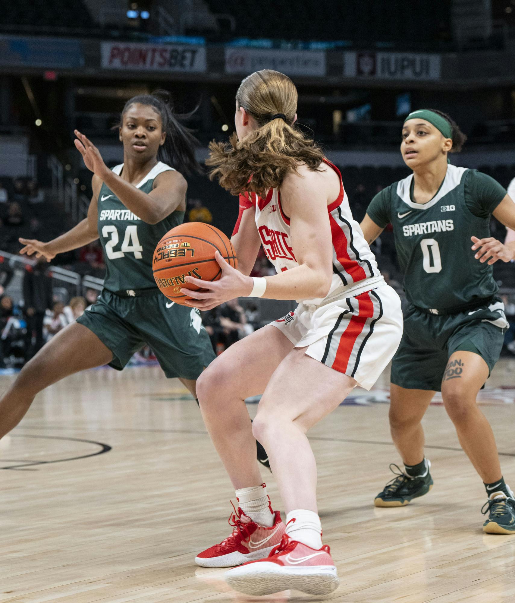 Clouden (24) and Hagemann (0) team up to guard Ohio State's Taylor Mikesell (24) in the Spartans’ contest against the Buckeyes at Gainbridge Fieldhouse in Indianapolis. - March 4, 2022.