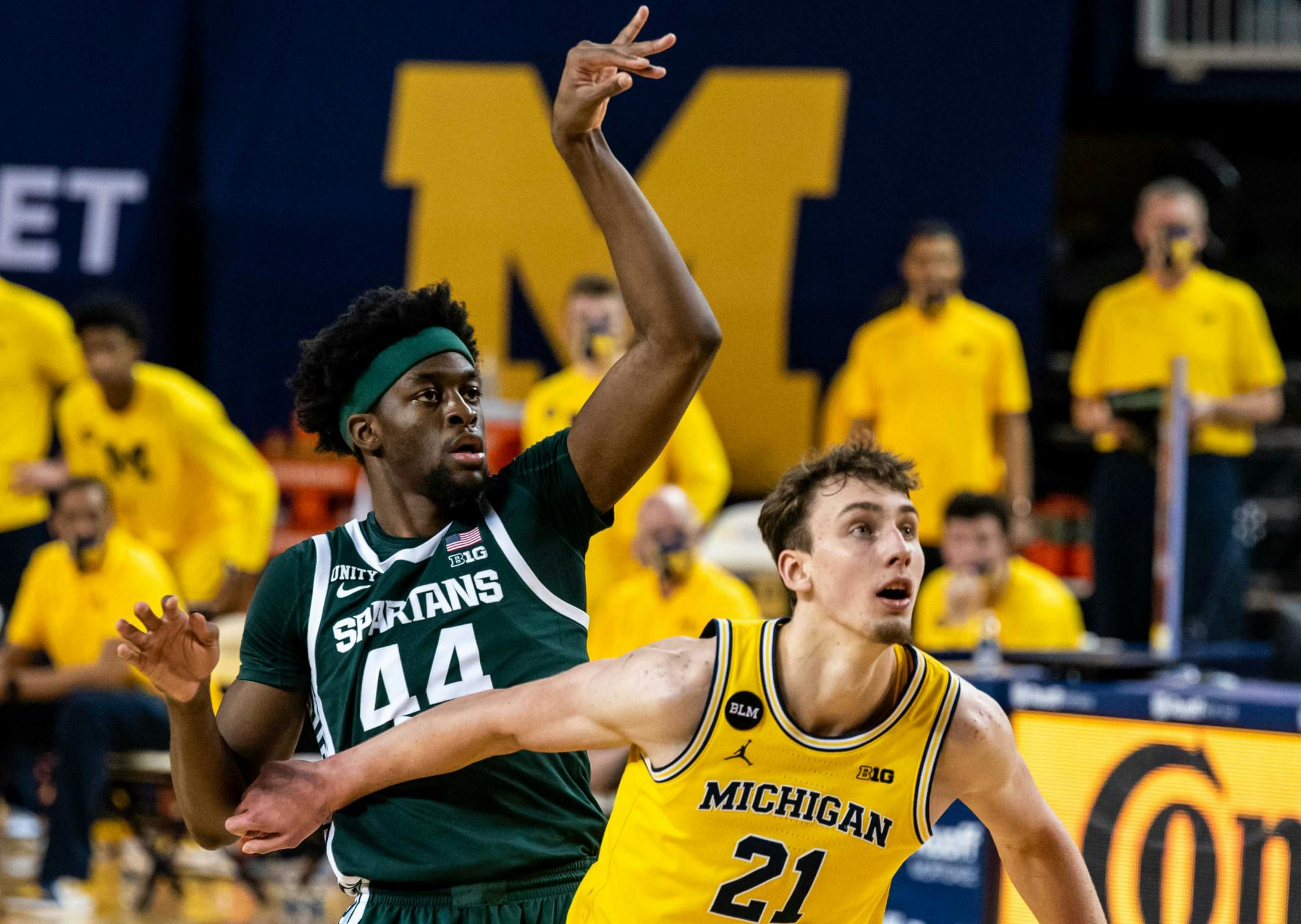 Junior forward Gabe Brown (44) shoots a free throw and is immediately shoved by a Michigan guard in the second half. The Wolverines crushed the Spartans, 69-50, at Crisler Center on Mar. 4, 2021. 