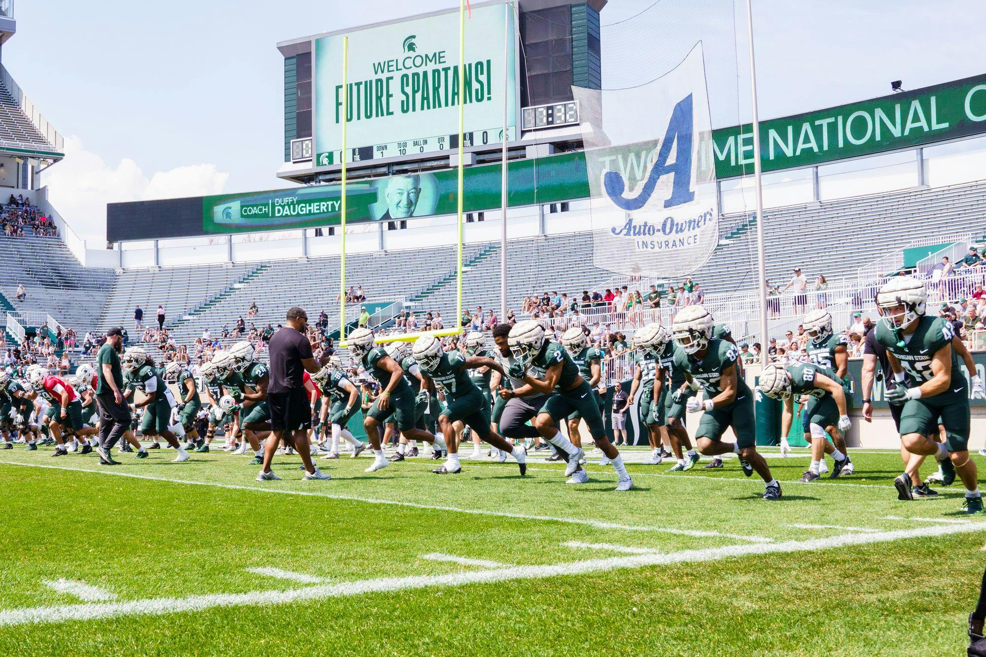The MSU football team warms up before their spring open practice, held at Spartan Stadium on April 15, 2023.