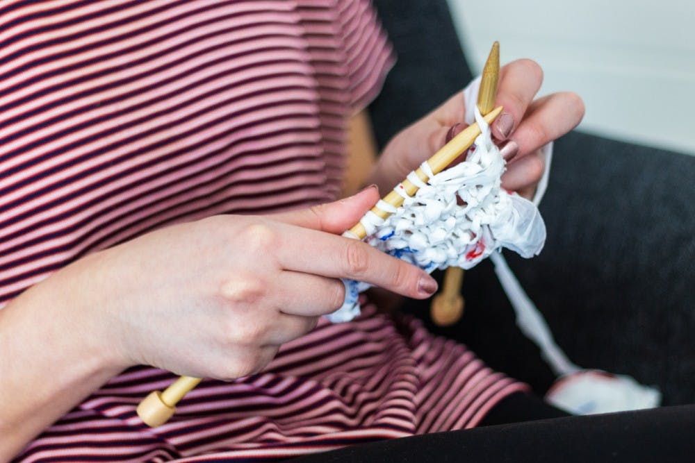 Plastic strips are knit into a sheet at the Waste Not Community Action Workshop on March 28, 2019.