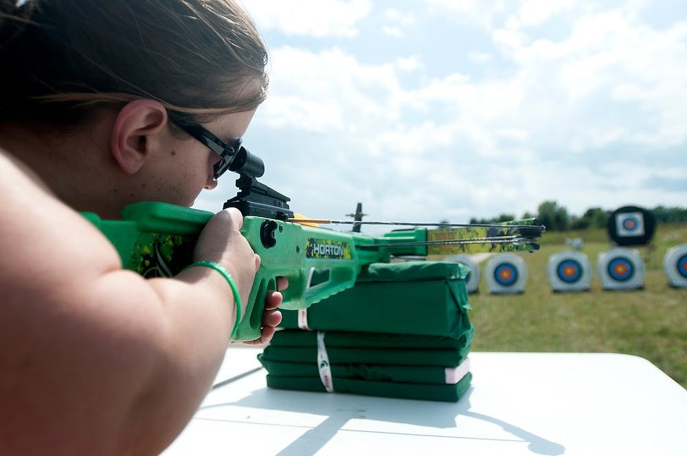 	<p>Tuscon, Arizona, resident Amy Morris shoots a crossbow Aug. 7, 2013, during the World Dwarf Games at Demmer Shooting Sports, Education and Training Center. It was her first time shooting a crossbow. Weston Brooks/The State News  </p>