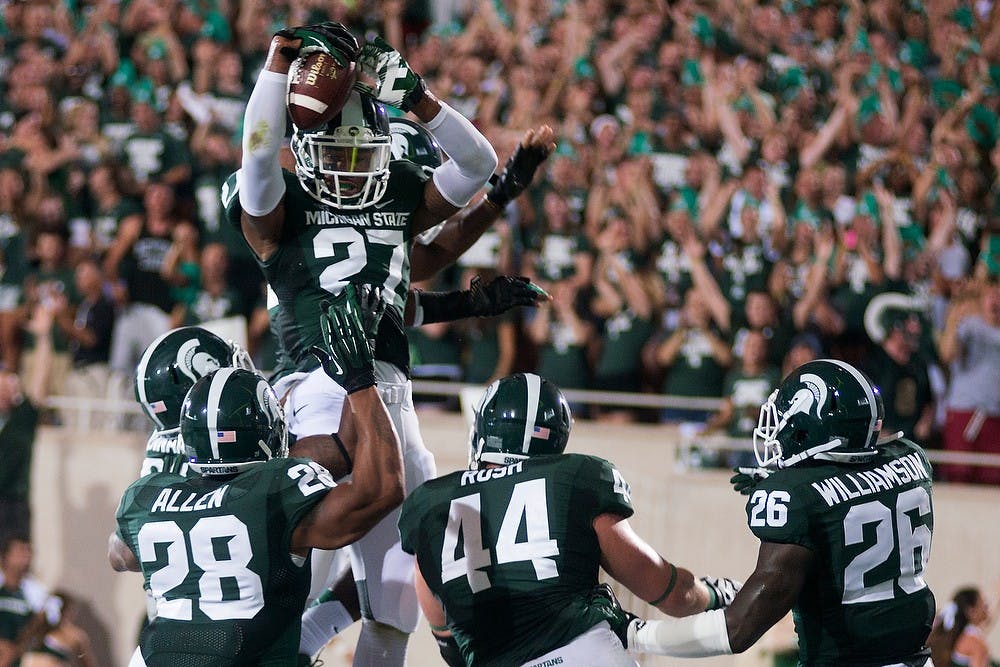 	<p>Junior safety Kurtis Drummond celebrates scoring a touchdown against Western Michigan on Aug. 30, 2013, at Spartan Stadium. The Spartans defeated the Broncos, 26-13. Julia Nagy/The State News</p>