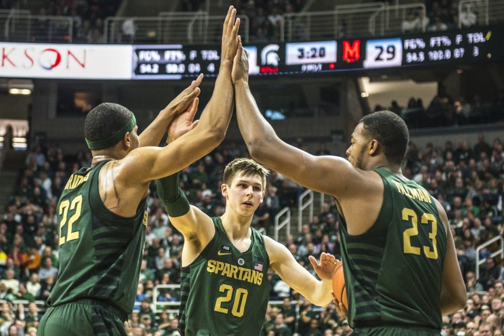 <p>Sophomore guard Miles Bridges (22), junior guard Matt McQuaid (20) and freshman forward Xavier Tillman (23) high five during the men's basketball game against Maryland on Jan. 4, 2018 at Breslin Center. (Nic Antaya | The State News)</p>