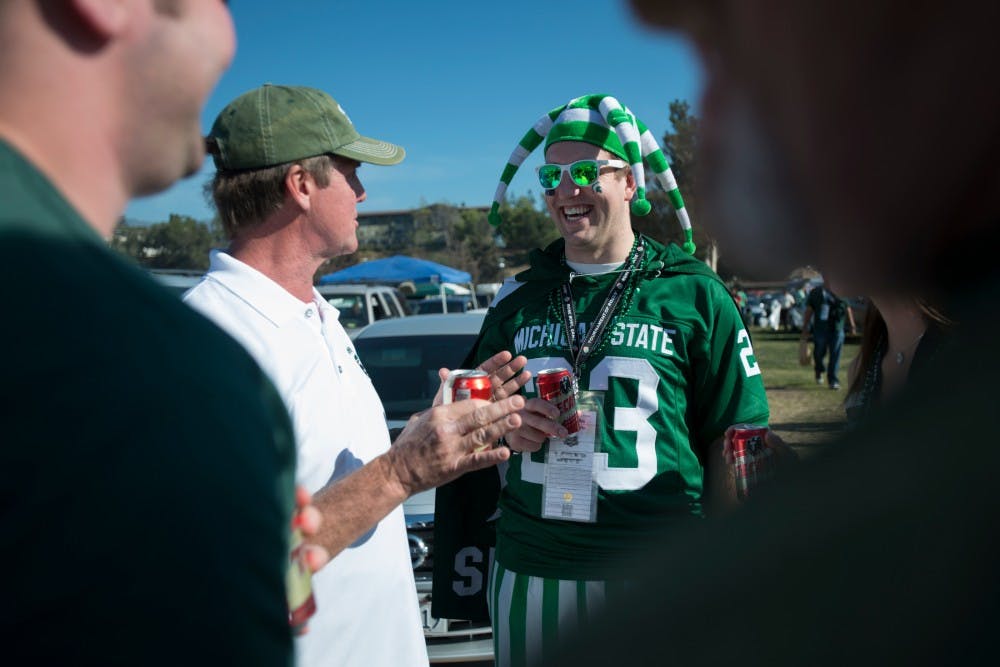 	<p><span class="caps">MSU</span> alumni John Cannon, left, and Jon Legg tailgate before the 100th Rose Bowl on Jan. 1, 2014, in Pasadena, Calif. Julia Nagy/The State News</p>