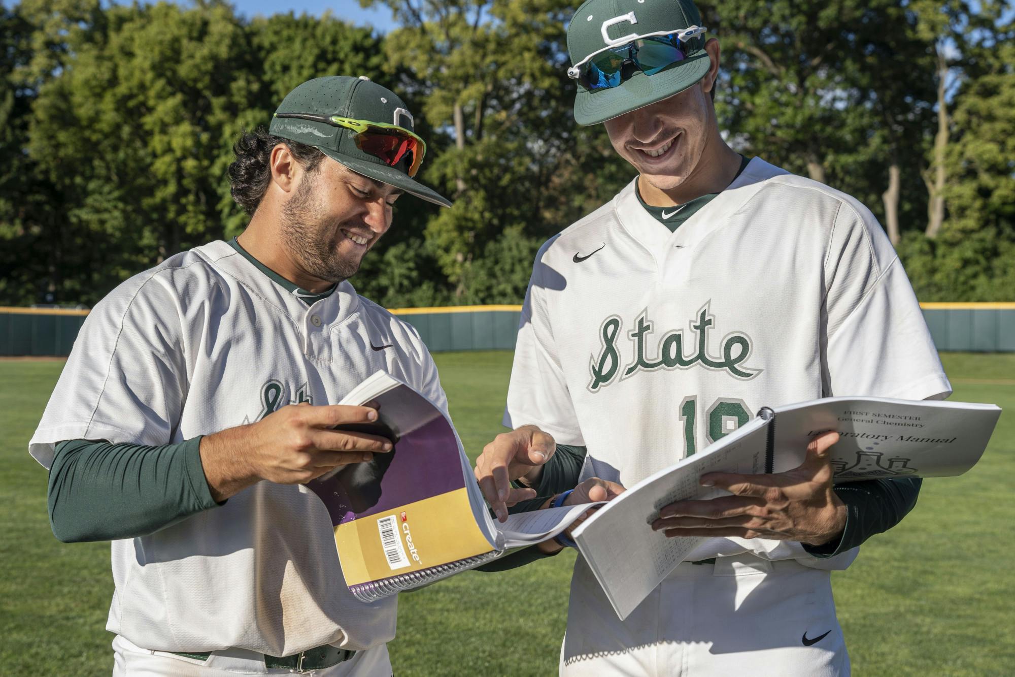 Sophomore second baseman Trent Farquhar, 1, and redshirt freshman Bryan Broecker, 19, compare notes after practice on Thursday, Sept. 22, 2022 at McLane Stadium.