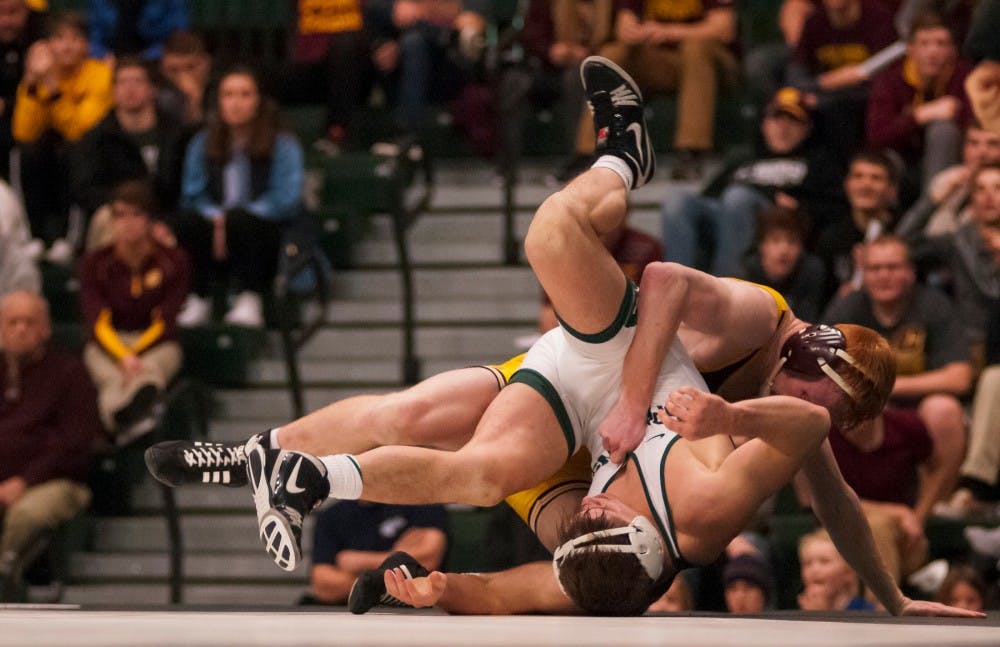 Sophomore 149-pounder Nick Trimble fights off Central Michigan 149-pounder Justin Oliver during the 2nd annual Tumbles and Takedowns on Jan. 20, 2017 at Jenison Field House. Tumbles and Takedowns is an event in which the MSU gymnastics and MSU wrestling team simultaneously compete in the Jenison Field House. The Spartan wrestlers were defeated by the Chippewas, 12-32.