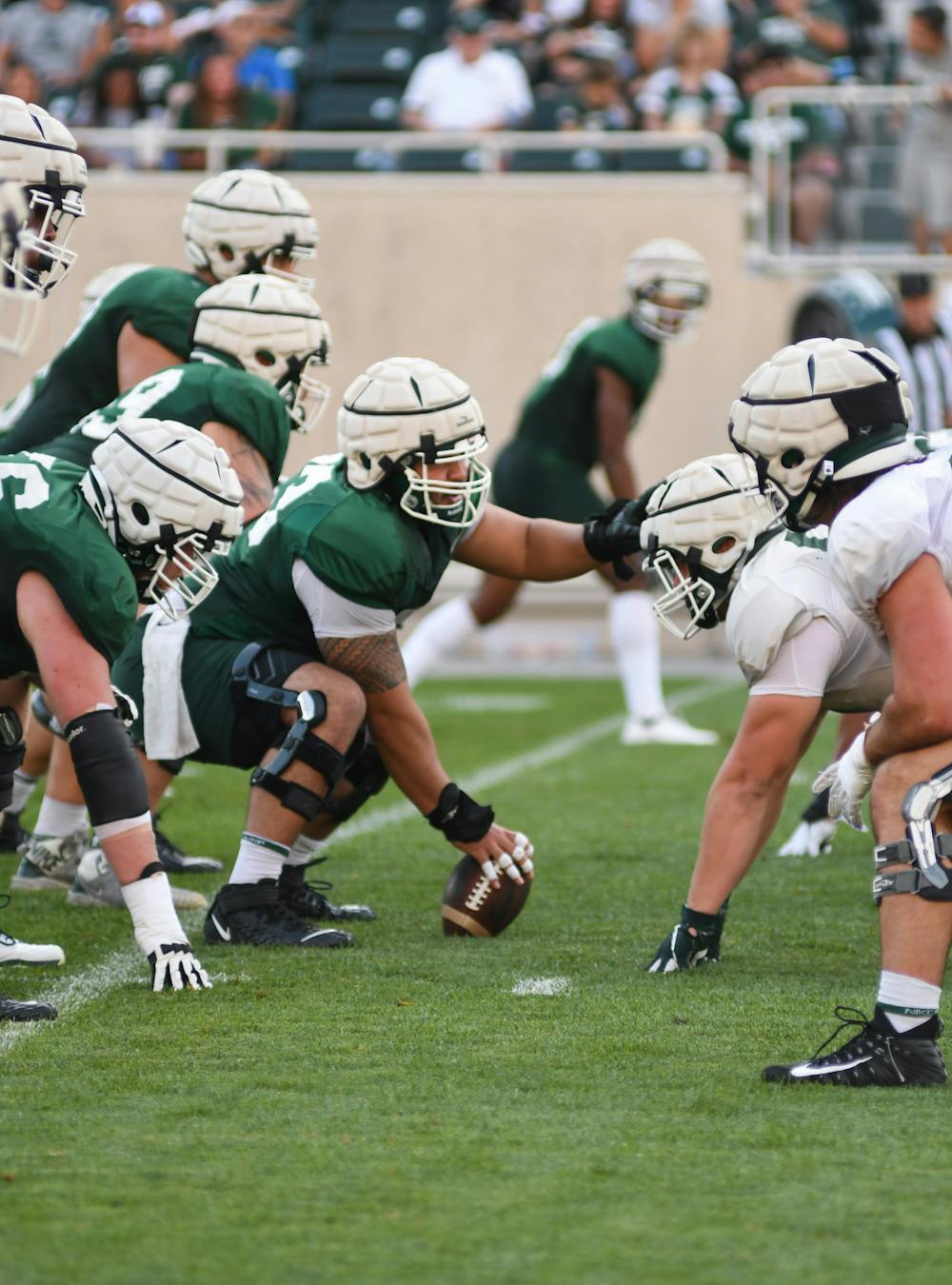 Senior Jacob Isaia prepares for the snap during a scrimmage-like drill at the team's "Meet the Spartans" event on Monday, August 23, 2021. 