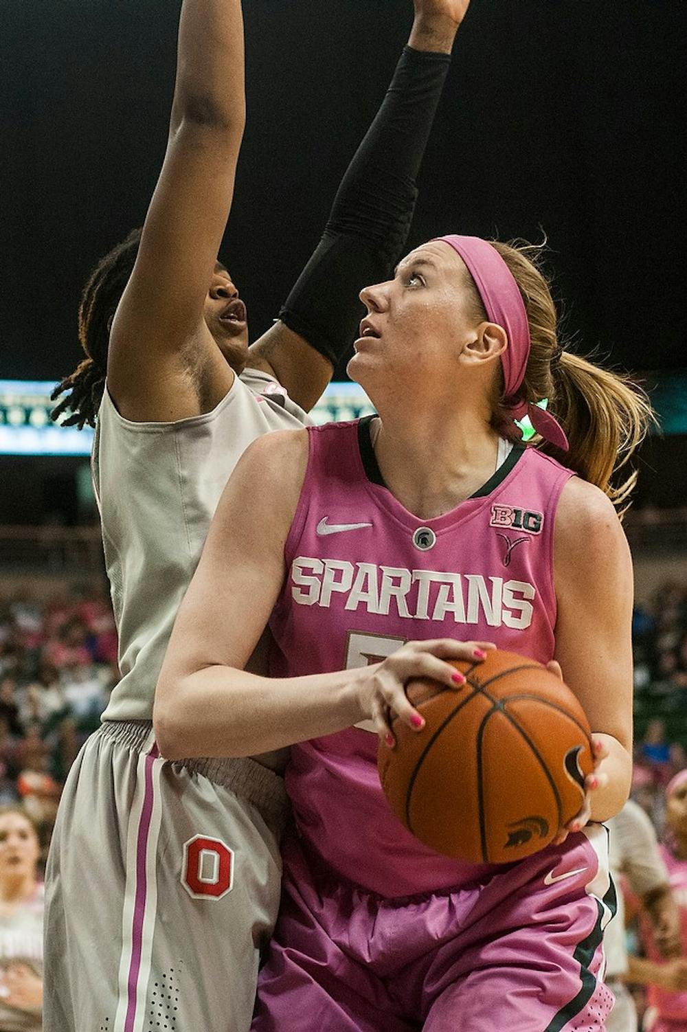 	<p>Junior forward Becca Mills goes up for the basket as Ohio State guard Raven Ferguson guards Feb. 15, 2014, at Breslin Center. The Spartans defeated the Buckeyes, 70-49. Erin Hampton/The State News</p>