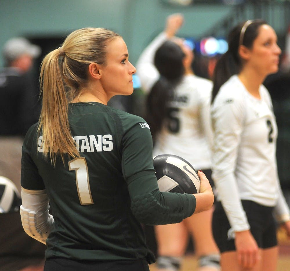 <p>Senior libero Kori Moster warms up Nov. 22, 2014 before the game against Rutgers at Jenison Field House. The Spartans defeated the Scarlet Knights, 3-0. Dylan Vowell/The State News</p>