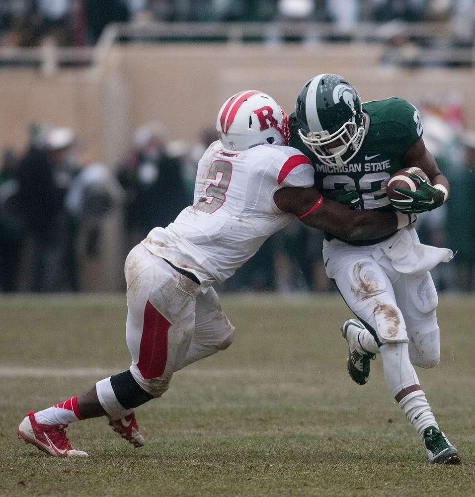 <p>Sophomore running back Delton Williams carries the ball as Rutgers linebacker Steve Longa attempts to tackle  Nov. 22, 2014, during the game at Spartan Stadium. The Spartans defeated the Scarlet Knights, 45-3. Aerika Williams/The State News</p>